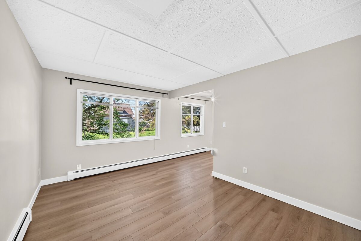 Spacious living area with windows and vinyl-plank flooring